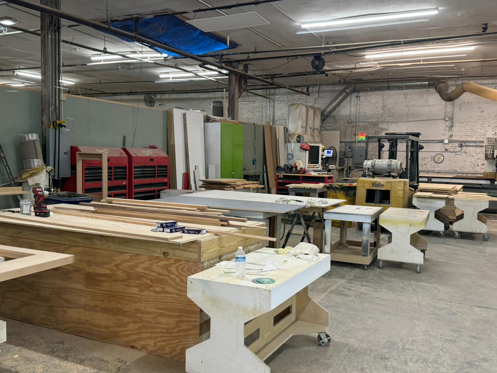 a large commercial millwork shop with machinery and wood